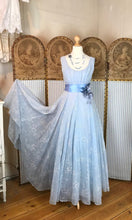 original authentic vintage 1950's blue organza full length empire line ball gown with a boat neckline, blue satin sash and pink corsage.