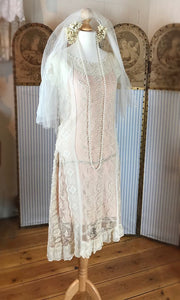 1920's lace wedding dress with dropped hem , cream lace over a peach slip, twenties veil with orange blossom