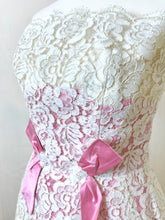 Close up of the french lace and rose pink silk taffeta inserts on a boned wedding dress from the sixties - for sale 