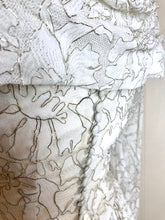 A detail of the self covered buttons which adorn a beautiful lace wedding gown from the fifties