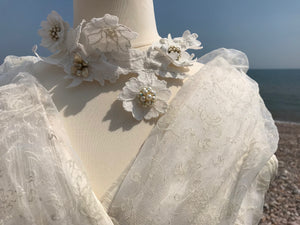 A close up of the shawl collar in translucent ivory organza on a 1950's wedding gown