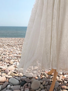 a close up of the ivory flocked organza fabric on a 1950's wedding dress