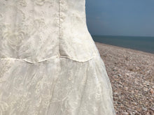 The scalloped waist of fifties wedding dress in ivory flocked organza 