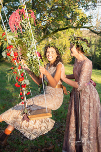 Boho country wedding inspiration - bride and bridesmaid on a floral swing in vintage dresses from Days of Grace. Bohemian flower crowns adorn their dark curls. Vintage bride inspiration with a modern twist 