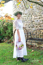 A model wears an original Edwardian wedding gown from days of Grace Vintage. The dress is white cotton lawn, with panels of broderie anglais, haned made lace and hand embroidery, all beautifully worked.