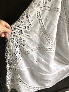 Close up the handmade bedfordshire lace and tape work on an Edwardian antique wedding gown 