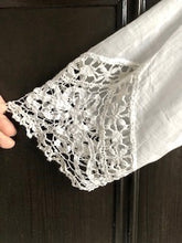 Close up the handmade bedfordshire lace and tape work cuff of an Edwardian wedding gown 