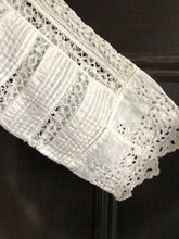 Close up of the handmade lace and broderie work on the sleeve cuff of an Edwardian wedding dress 