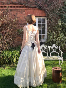 An elegant ivory silk Victorian corset wedding dress is laced with black lacings. The dress is in fact two separates - a corset top and full skirt. The dress could be worn as a wedding dress or a Victorian costume